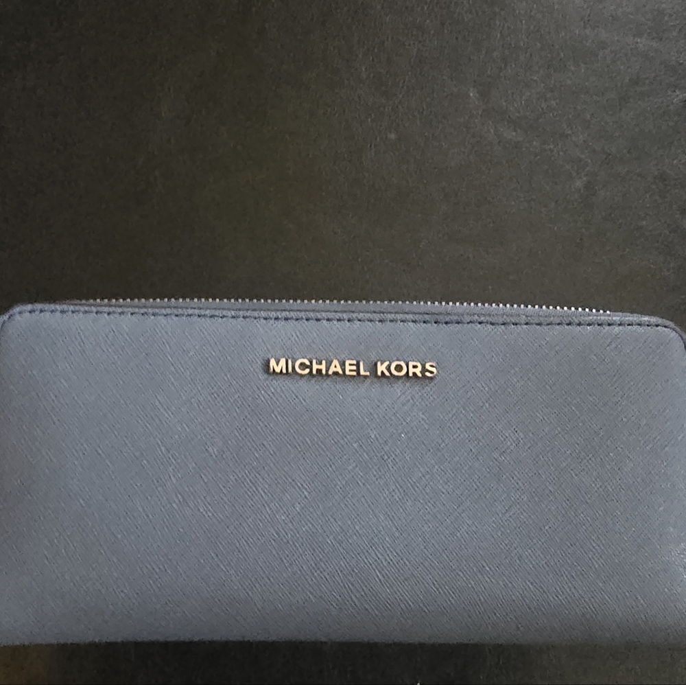 Michael Kors wallet. Blue in color. Zippered.